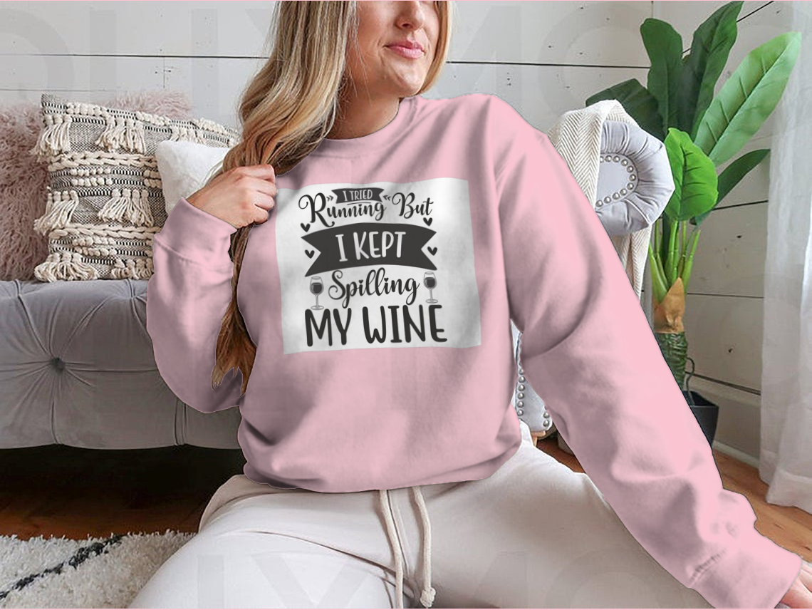 A cozy sweatshirt featuring the humorous phrase 'I Tried Running But I Kept Spilling My Wine', perfect for wine lovers.